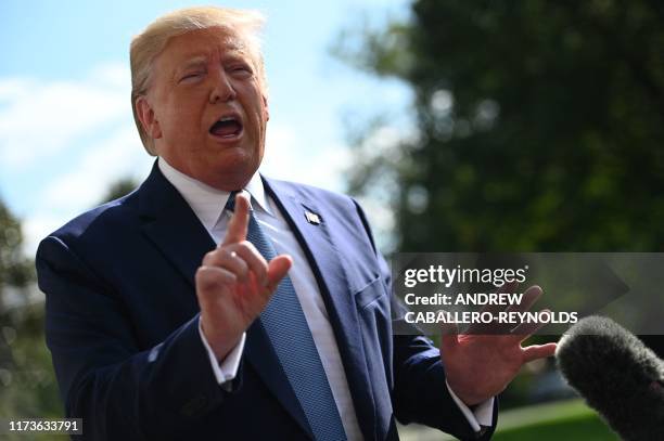 President Donald Trump speaks to the press as he departs the White House in Washington, DC, for his annual visit to Walter Reed National Military...