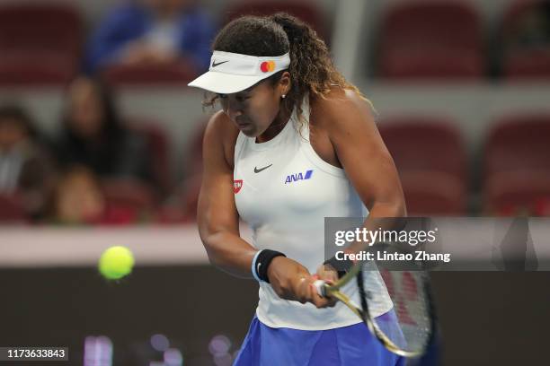 Naomi Osaka of Japan returns a shot against Bianca Andreescu of Canada during the Women's singles Quarter Finals of 2019 China Open at the China...