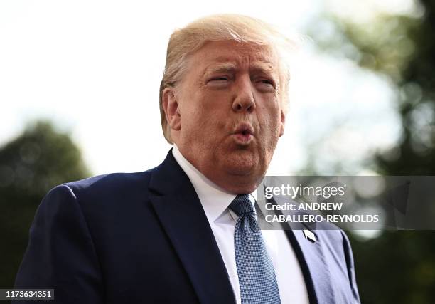 President Donald Trump speaks to the press as he departs the White House in Washington, DC, for his annual visit to Walter Reed National Military...