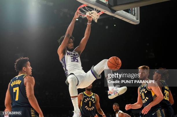 Sacramento Kings player Marvin Bagley shoots a ball as Indiana Pacers players Domantas Sabonis and Malcolm Brogdon look on during the first...