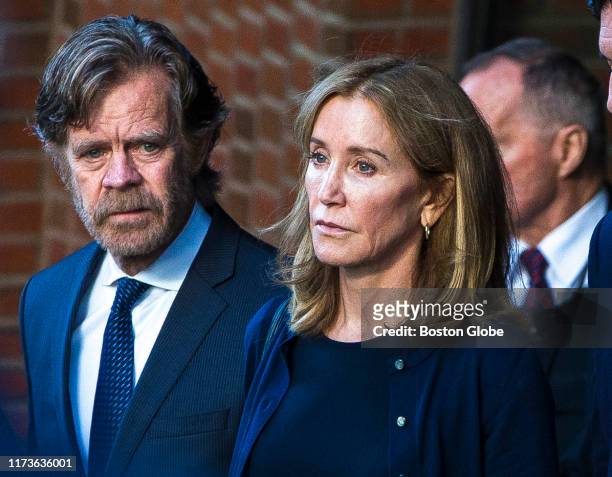 Felicity Huffman, right, and her husband, William H. Macy, walk out of the John Joseph Moakley United States Courthouse in Boston on Sep. 13, 2019....