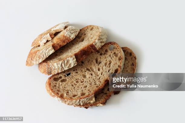 sliced black bread, homemade rye bread on a white background. copy space, healthy eating. - rye grain stockfoto's en -beelden