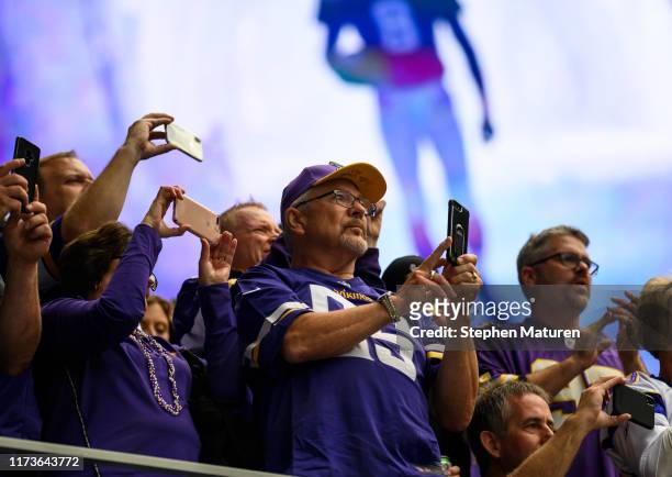 Fans with their phones out during pregame introductions before the game between the Minnesota Vikings and Atlanta Falcons at U.S. Bank Stadium on...