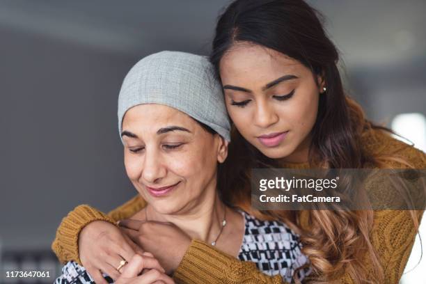 courageous woman with cancer spends precious time with adult daughter - cancer patient portrait stock pictures, royalty-free photos & images