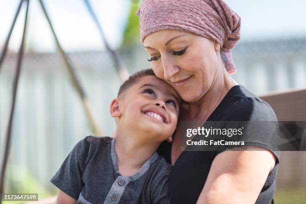 woman with cancer spends precious time with her toddler son - cancer hope stock pictures, royalty-free photos & images