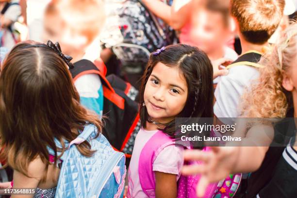 schoolgirl in line with her classmates - crowd anticipation stock pictures, royalty-free photos & images