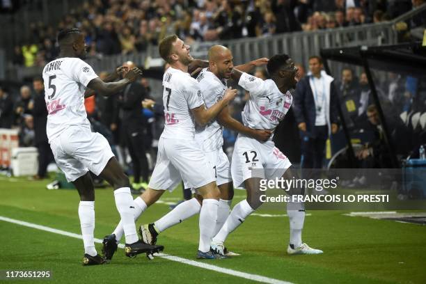 Amiens' Norwegian defender Haitam Aleesami is congratulated by teammates after scoring a goal during the French L1 football match between SC Amiens...