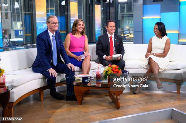 Steve Doocy, Lisa Boothe, Brian Kilmeade and Former U.S. Secretary of State Condoleeza Rice speak during "FOX & Friends" at Fox News Channel Studios...