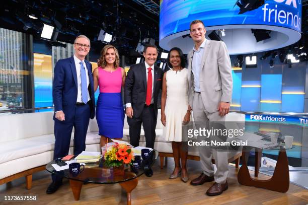 Steve Doocy, Lisa Boothe, Brian Kilmeade, Former U.S. Secretary of State Condoleeza Rice and Rob Gronkowski pose for a photo on the set of "FOX &...