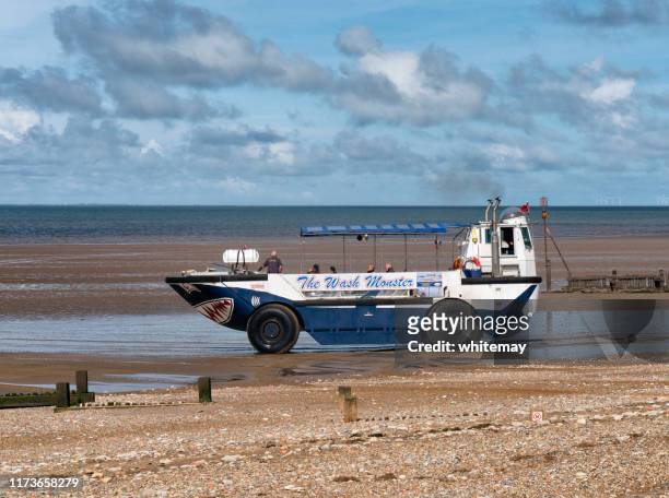 the wash monster setting out from hunstanton beach at low tide - amphibious vehicle stock pictures, royalty-free photos & images