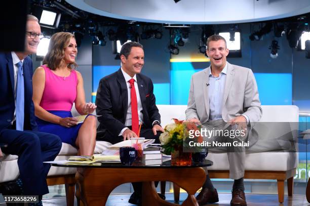Steve Doocy, Lisa Boothe, Brian Kilmeade and Rob Gronkowski speak on "FOX & Friends" at Fox News Channel Studios on September 10, 2019 in New York...