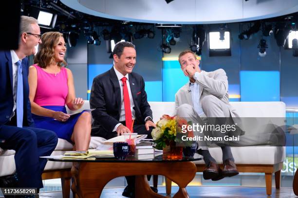 Steve Doocy, Lisa Boothe, Brian Kilmeade and Rob Gronkowski speak on "FOX & Friends" at Fox News Channel Studios on September 10, 2019 in New York...
