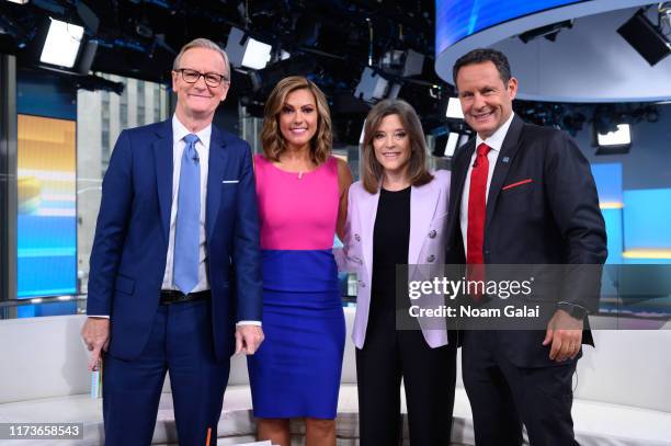 Steve Doocy, Lisa Boothe, Marianne Williamson and Brian Kilmeade pose for a photo during a taping of Fox & Friends at Fox News Channel Studios on...