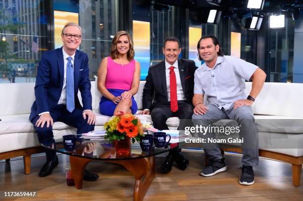 Steve Doocy, Lisa Boothe, Brian Kilmeade and Johnny Damon pose for a photo during "FOX & Friends" at Fox News Channel Studios on September 10, 2019...