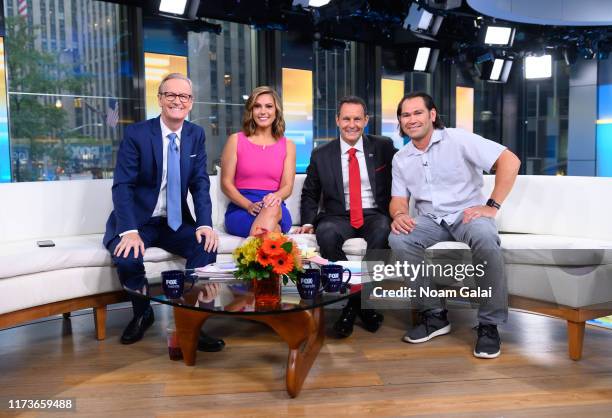 Steve Doocy, Lisa Boothe, Brian Kilmeade and Johnny Damon speak during "FOX & Friends" at Fox News Channel Studios on September 10, 2019 in New York...