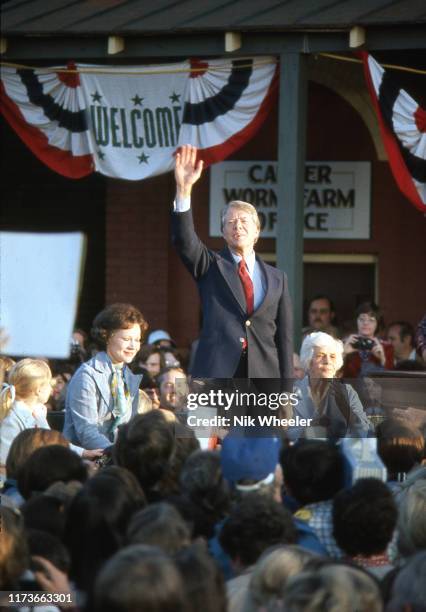 Newly elected President Jimmy Carter with his wife and mother salutes the crowd of supporters at a victory rally in his home town of Plains Georgia...