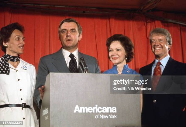 Vice Presidential candidate Walter Mondale stands at lectern with his wife Eleanor and presidential candidate Jimmy Carter and wife Rosalynn during...