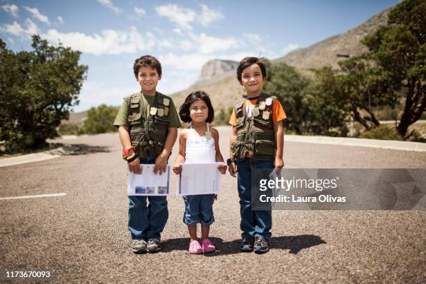 Portrait of Children on Street Holding Booklets