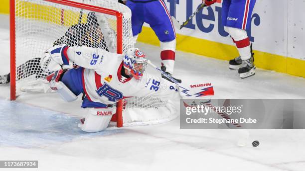 Charlie Lindgren of the Laval Rocket sweeps the puck away from the net against the Clevland Montsters at Place Bell on October 4, 2019 in Laval,...
