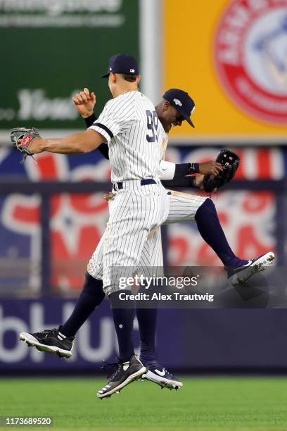Aaron Judge and Cameron Maybin of the New York Yankees celebrate after the New York Yankees win Game 1 of the ALDS between the Minnesota Twins and...