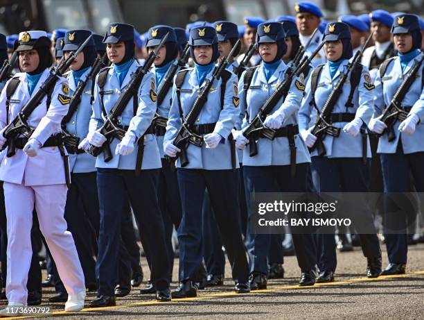 Female troops parade during a ceremony marking the 74th anniversary of the Indonesian military at Halim air force base in Jakarta on October 5, 2019.