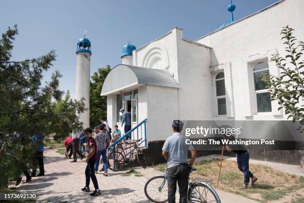 Men leave the local mosque after attending Friday prayers in the town of Baidibek Bi near Kazakhstans border with China . Several families in the...