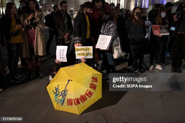 Protesters hold placards during the demonstration. Protesters rallied at Trafalgar Square to demand democracy and justice in Hong Kong and to protest...