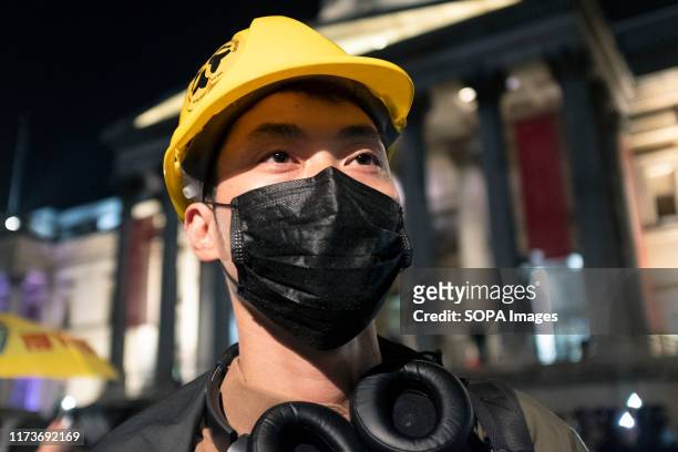 Protester wearsa yellow helmet and mask during the demonstration, Protesters rallied at Trafalgar Square to demand democracy and justice in Hong Kong...
