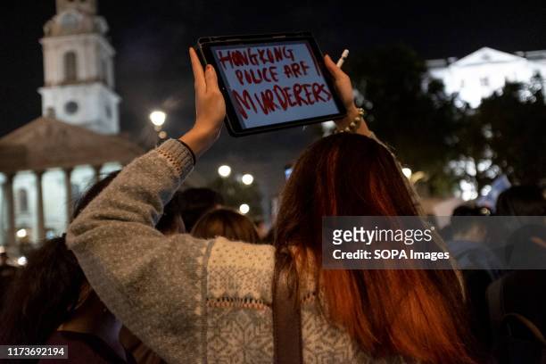 Protester holds a placard during the demonstration. Protesters rallied at Trafalgar Square to demand democracy and justice in Hong Kong and to...
