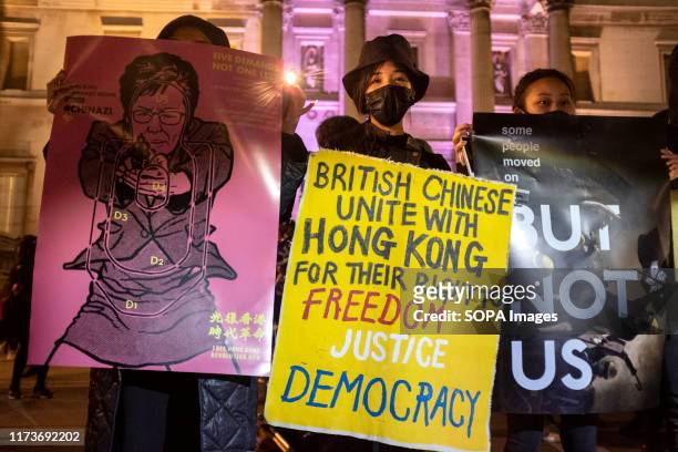 Protesters hold placards during the demonstration. Protesters rallied at Trafalgar Square to demand democracy and justice in Hong Kong and to protest...