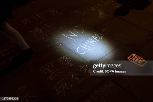 Protesters wrote on the pavement during the demonstration. Protesters rallied at Trafalgar Square to demand democracy and justice in Hong Kong and to...