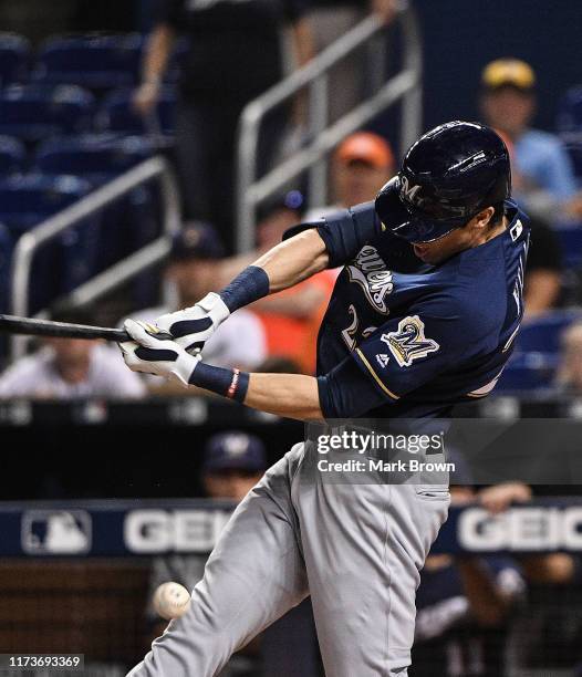 Christian Yelich of the Milwaukee Brewers hits the ball off his knee in the first inning against the Miami Marlins at Marlins Park on September 10,...