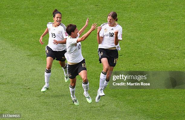 Kerstin Garefrekes of Germany celebrate with her team mates after she scores her team's opening goal during the FIFA Women's World Cup 2011 Group A...