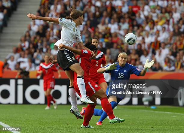 Kerstin Garefrekes of Germany scores the opening goal during the FIFA Women's World Cup Group A match between Germany and Canada at Olympic Stadium...