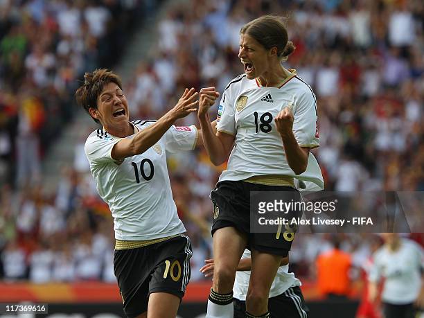 Kerstin Garefrekes of Germany celebrates with Linda Bresonik after scoring the opening goal during the FIFA Women's World Cup Group A match between...