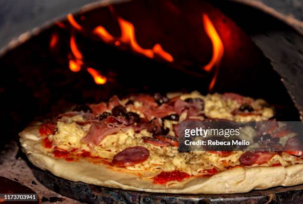 homemade pepperoni pizza baking inside the wood oven - pizzaugn bildbanksfoton och bilder