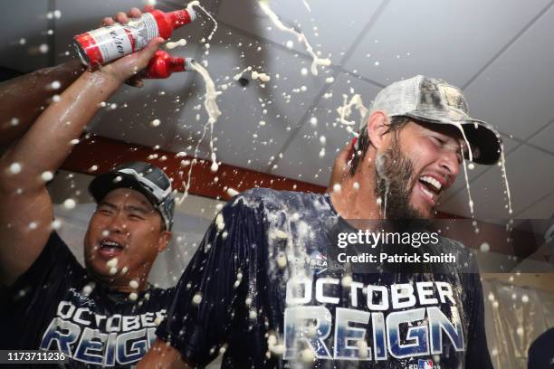 Clayton Kershaw of the Los Angeles Dodgers and teammates celebrate in the clubhouse after defeating the Baltimore Orioles and clinching the National...