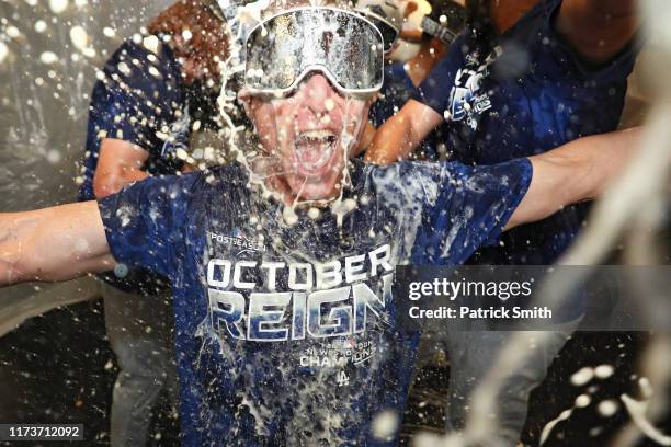 Hitting coach and hitting strategist Brant Brown of the Los Angeles Dodgers celebrates with his team in the clubhouse after defeating the Baltimore...