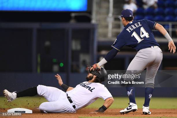 Jorge Alfaro of the Miami Marlins is tagged in the face while caught stealing second base by Hernan Perez of the Milwaukee Brewers in the eighth...