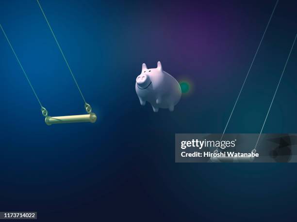 piggy bank doing aerial swing - zirkus stock-fotos und bilder