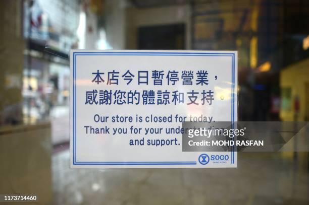 Sign is pictured on the entrance to Sogo department store, closed due planned protests and transport closures, in the Causeway Bay area of Hong Kong...