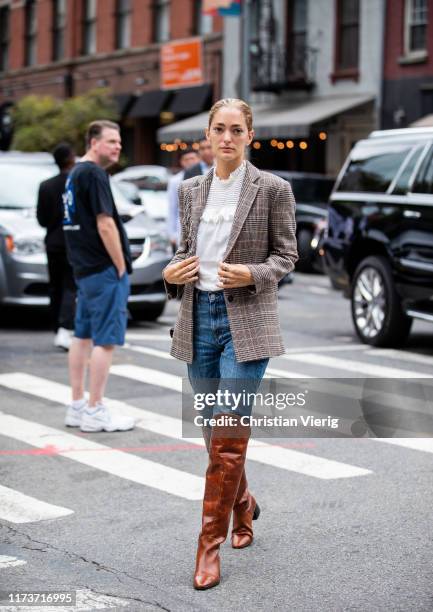 Sofia Sanchez de Betak is seen wearing denim jeans, checkered blazer, brown boots, white blouse outside Gabriela Hearst during New York Fashion Week...