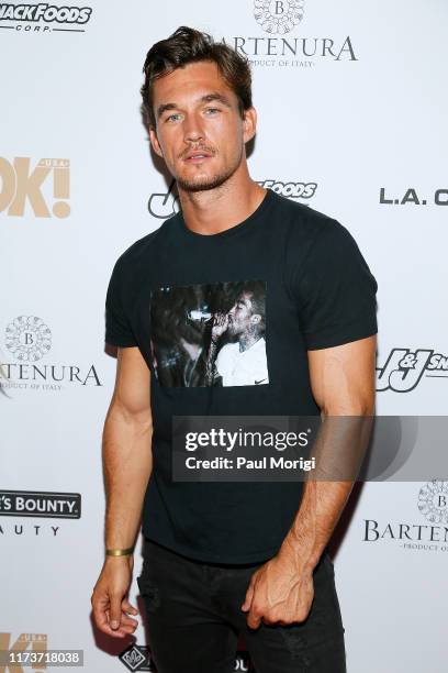 Tyler Cameron attends the OK! Magazine NYFW Party at PhD, Dream Downtown Hotel Rooftop on September 10, 2019 in New York City.