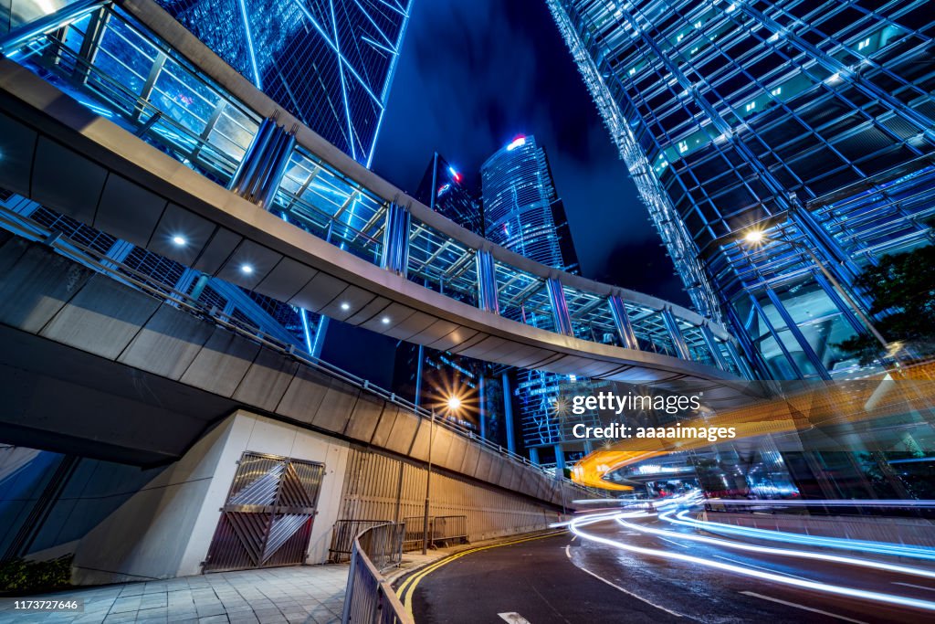 Low angle view of a long covered footbridge links up modern office buildings