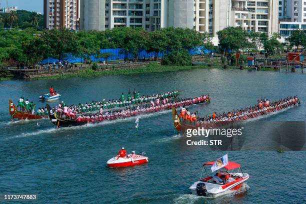 Rowers on traditional wooden boats from Kerala known as snake boats participate in the Champions Boat League held at the backwaters of Kochi in...
