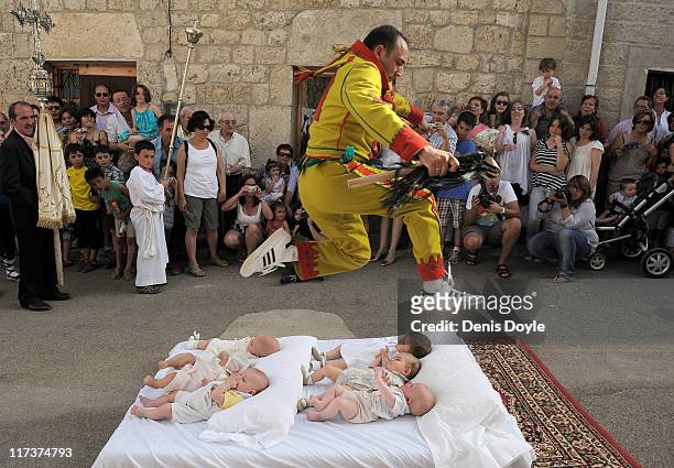Man representing the devil leaps over babies during the festival of El Colacho on June 26, 2011 in Castrillo de Murcia near Burgos, Spain. The...
