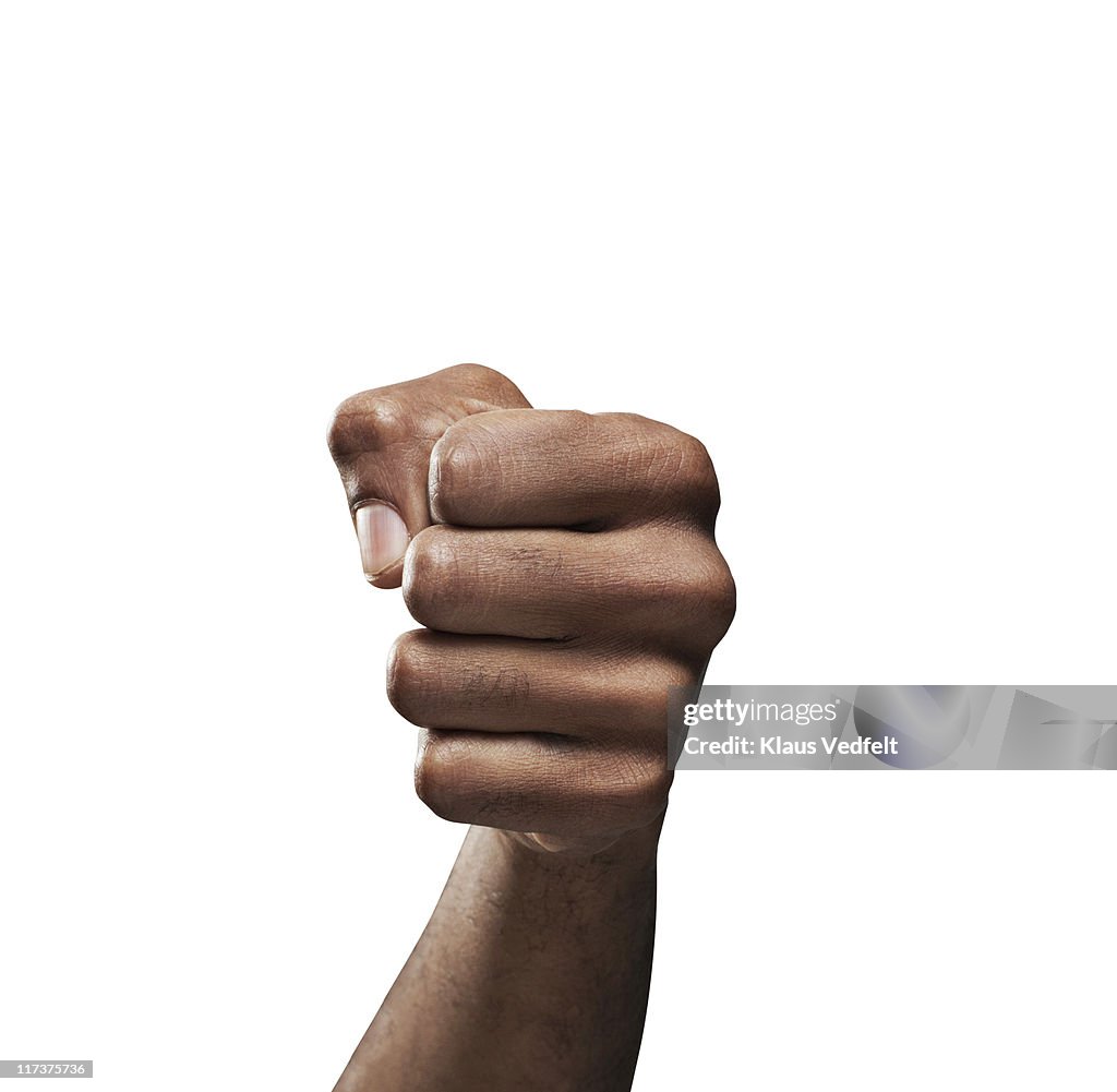 Close-up of man's fist on white background