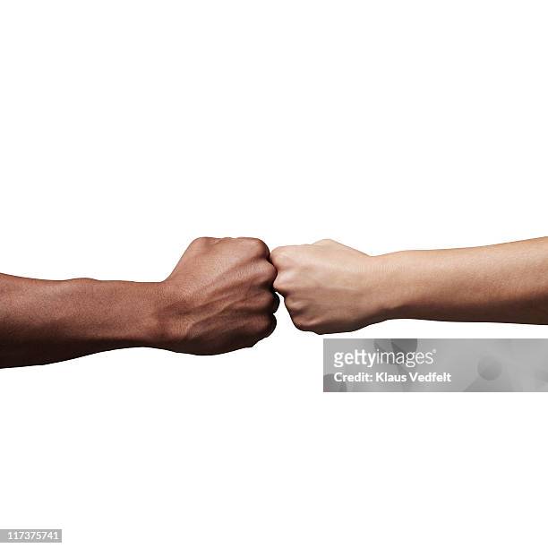 man and woman holding fists together - vuist stockfoto's en -beelden