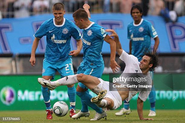 Viktor Fayzulin of FC Zenit St. Petersburg battles for the ball with Mauricio of FC Terek Grozny during the Russian Football League Championship...