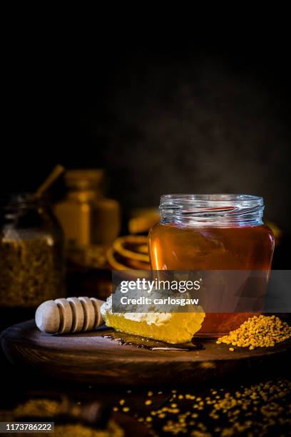 honey jar, honeycomb and bee pollen - honey jar stock pictures, royalty-free photos & images